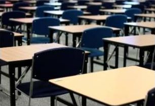 Empty exam hall with rows of desks