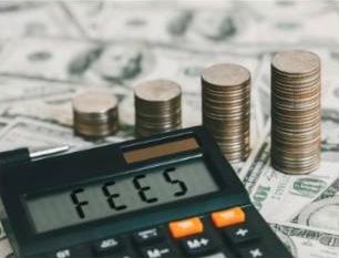 Calculator showing the word fees next to stacks of coins