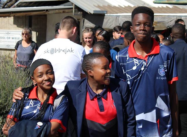 A group of learners gathered outside the school of music